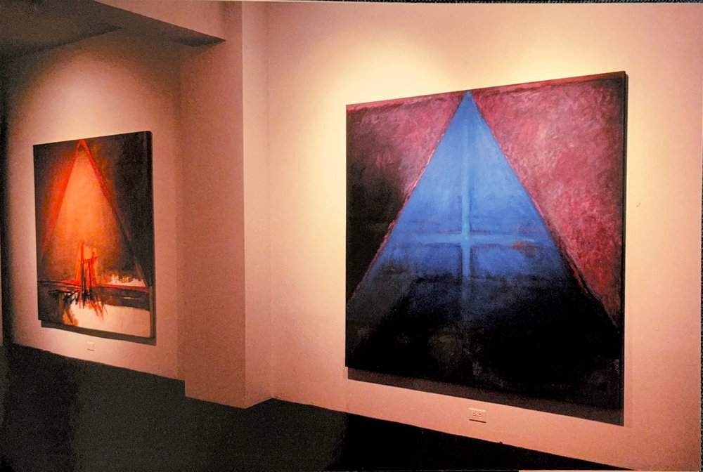 Gallery installation view showing two paintings